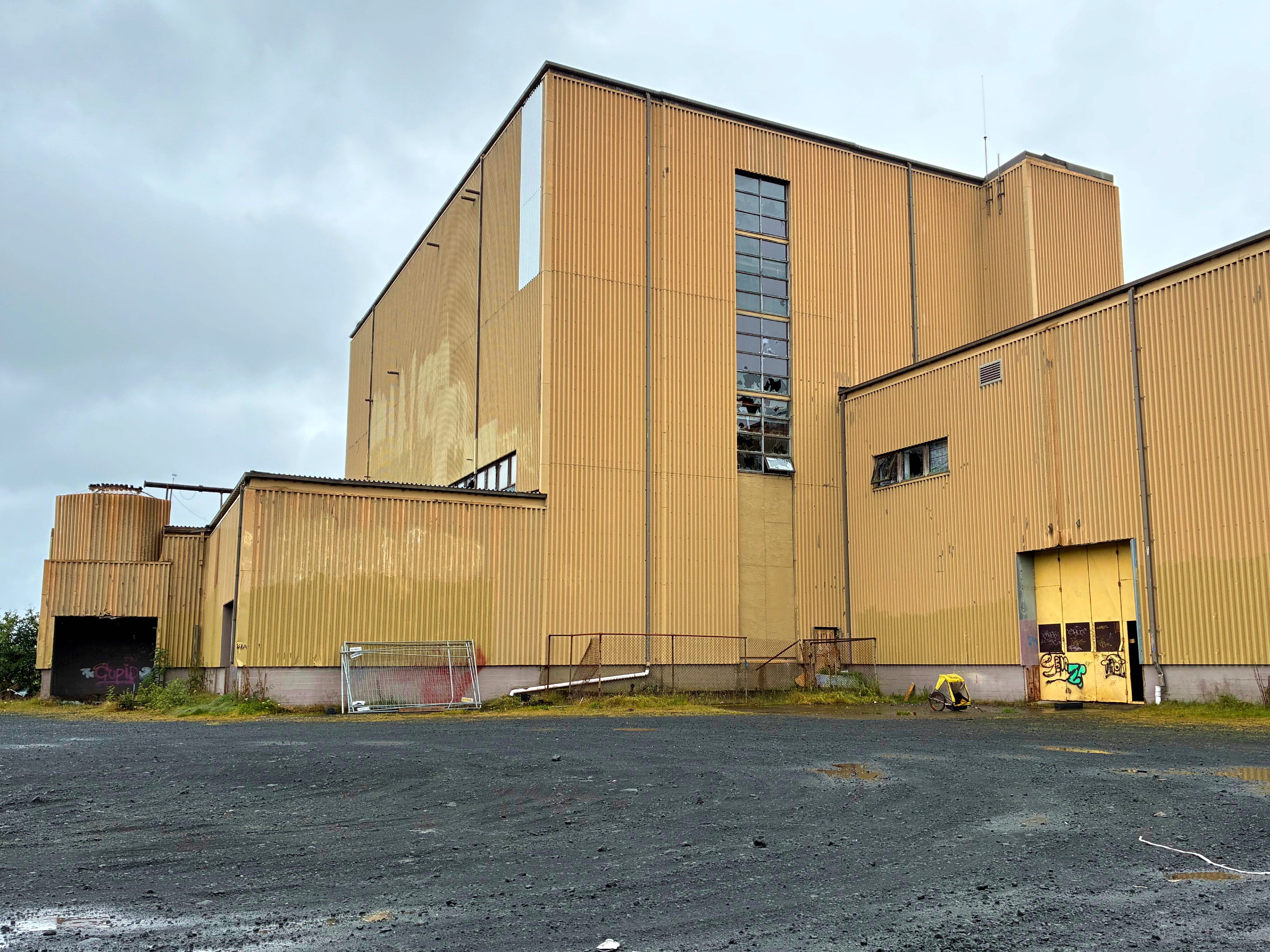 A large yellow building with broken windows.