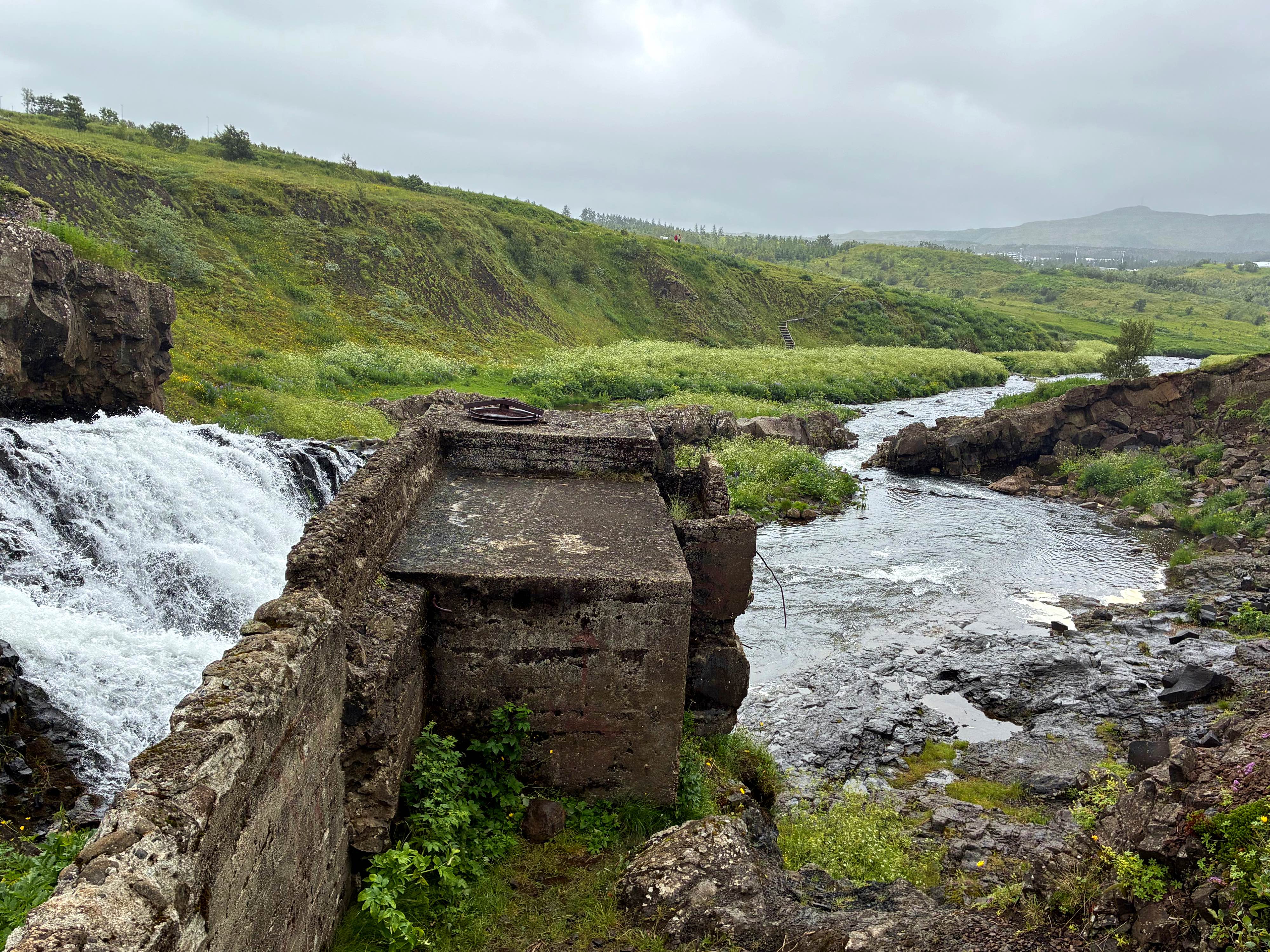 An abandoned mini hydro power station next to a river.